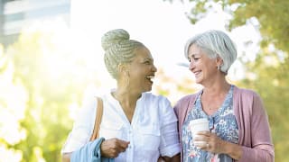 two older people walking outside smiling.jpg
