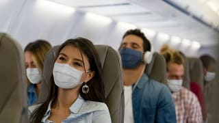 Masked passengers on a plane GaAbt.width .jpg