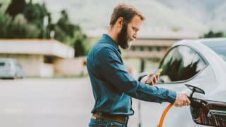 Person connecting their EV to power source wh.width .jpg