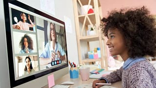 gettyimages child interacting with others on computer.jpg