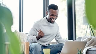 person celebrating success on laptop.jpg
