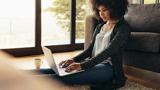 person sitting on floor using laptop.jpg