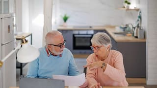 senior couple at a desk serious gettyimages .jpg
