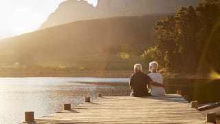 senior man and woman sitting at the end of a .width eBYYor.jpg