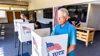 election day person voting in booth.jpg
