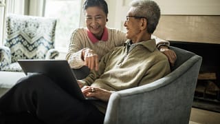smiling senior couple using laptop at home.jpg