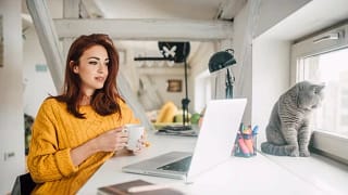 YoungWomanWithCatLookingAtLaptop.width scTOOW.jpg