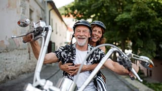 getty smiling happy couple on motorcycle.jpg