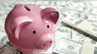 gettyimages piggy bank on a pile of money.jpg