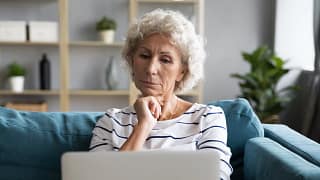 person with hand on chin looking at laptop.jpg