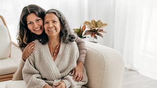 two people sitting on a couch and smiling.jpg