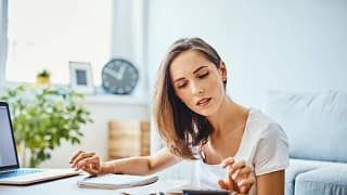 woman with calculator at home.width .jpg
