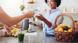 Cashier at cafe running credit card iqMfc.width .jpg