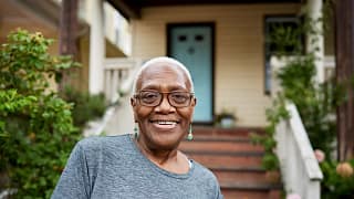 getty smiling happy by porch house.jpg
