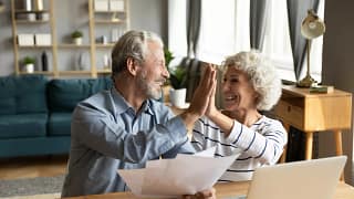 retired couple reviewing finances on a laptop.jpg