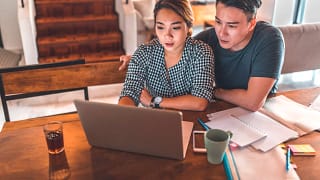 serious couple looking at laptop and discussing finances.jpg