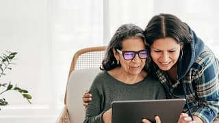 two people looking at a tablet and smiling.jpg