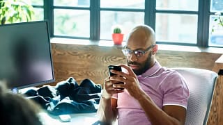 Man looking at phone contemplative QBnEzD.width .jpg