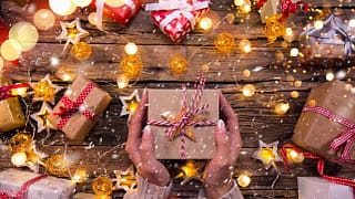 Woman holding wrapped gift YvsdKw.width .jpg