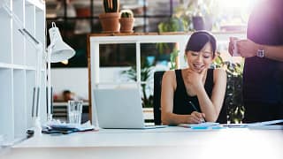 Woman working in office CmcykUG.width .jpg