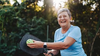 getty happy smiling pickleball player exercise fitness sports.jpg