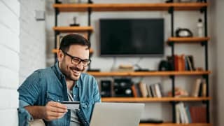 man with credit card and laptop.width .jpg