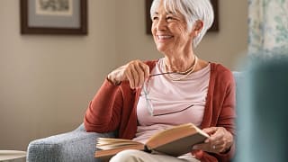 senior woman smiling book gettyimages .jpg
