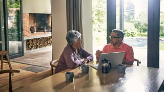two people at a table with a laptop open gettyimages .jpg