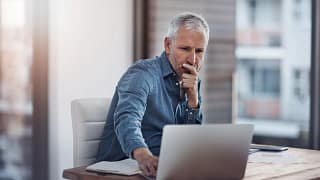 older man denim shirt laptop gettyimages .jpg