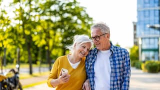 smiling couple walking down street together.jpg