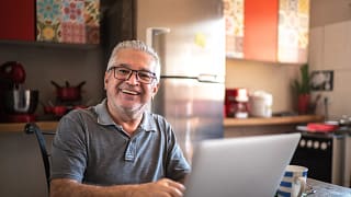 older man laptop smiling gettyimages .jpg