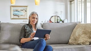 older woman couch tablet gettyimages .jpg