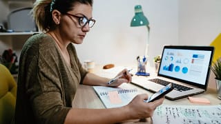 female investor reviewing her portfolio on a laptop.jpg