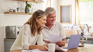 older couple smiling laptop gettyimages .jpg