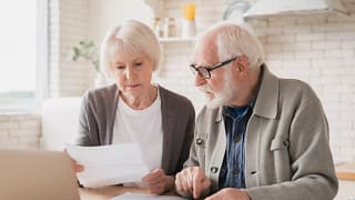 senior couple laptop documents gettyimages .jpg
