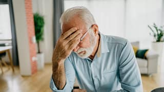 senior man holding face gettyimages .jpg