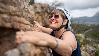 smiling person rock climbing.jpg