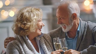 smiling seniors clinking champagne glasses together.jpg