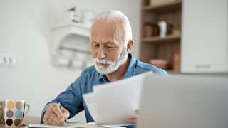 older man at desk serious gettyimages .jpg