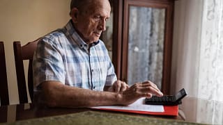 older man calculator gettyimages .jpg