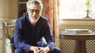 getty beard sitting serious expression blue shirt.jpg