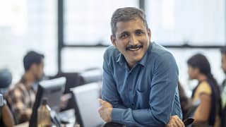 getty happy smiling business person at office.jpg
