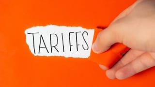 tariffs on torn orange paper.jpg