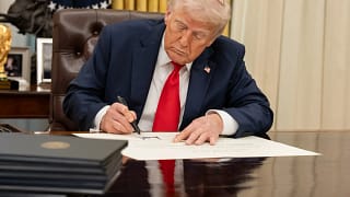 white house president donald trump signing executive order at resolute desk in oval office.jpg