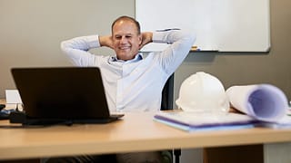 man s desk smiling gettyimages .jpg