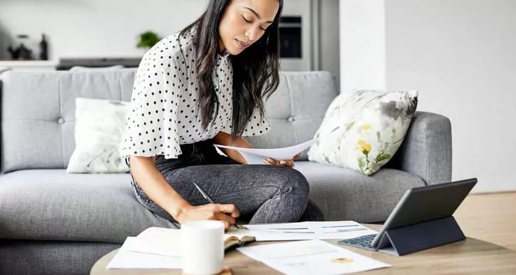 woman on couch with papers and tablet hBtEvpP.width .jpg