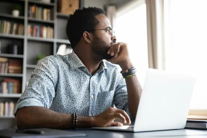 worried man at laptop looking out window.width .jpg