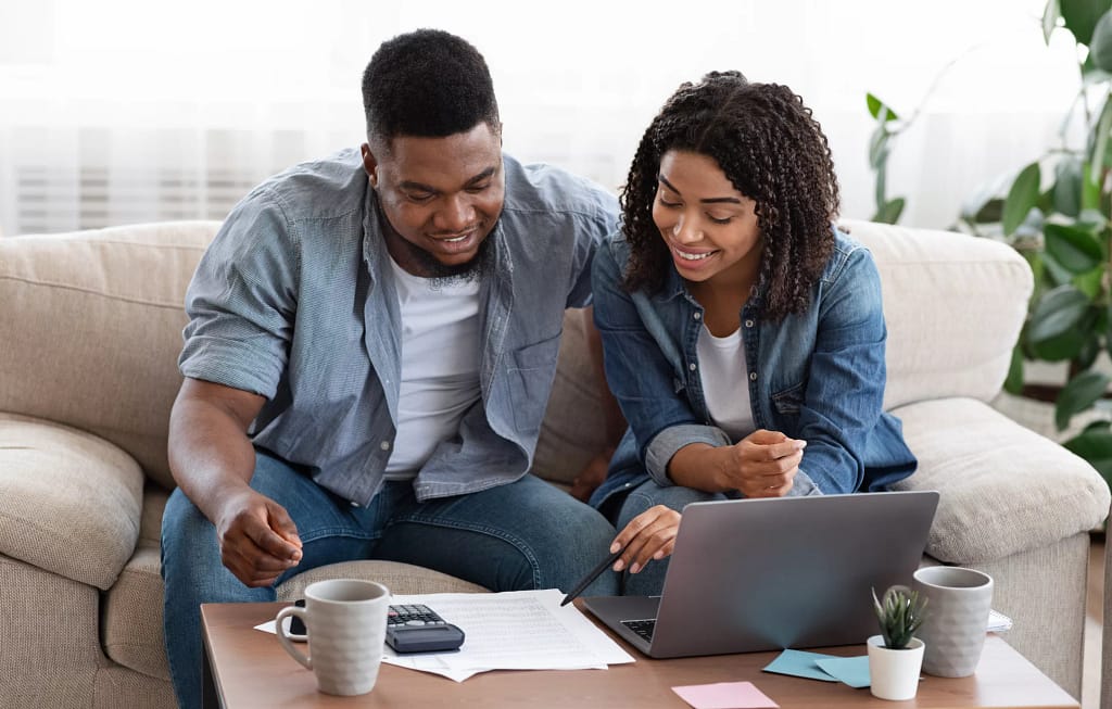 smiling couple looking at documents.jpg