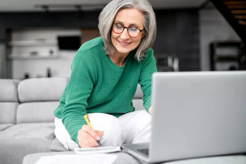older adult in living room reviewing finances.jpg