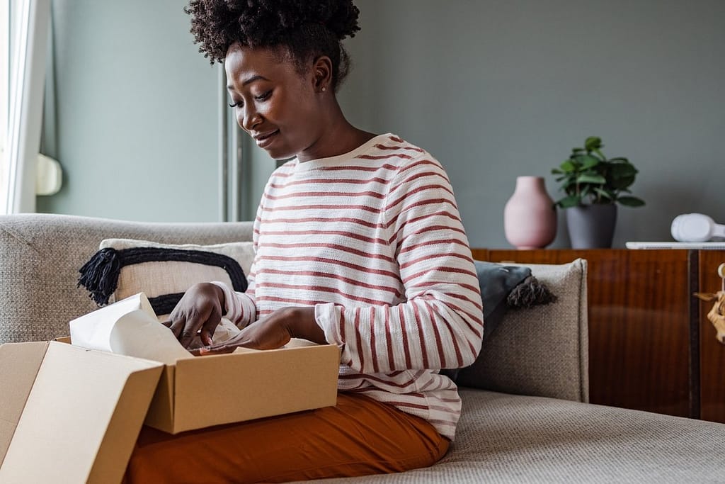 Woman packing up box to return item. juBzvHy.width